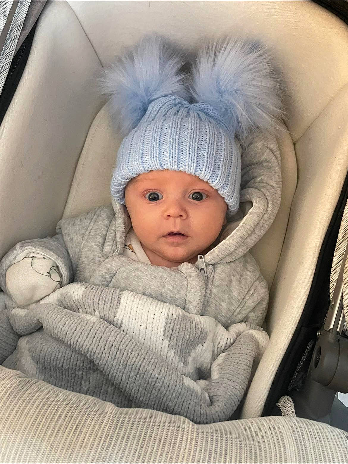 Keenan is registered to the contest to win money with this photo: baby, baby_products, baby_sleeping, baby_toddler_clothing, beanie, cap, car_seat, car_seat_cover, cheek, child, comfort, family_car, fur, headgear, headwear, knit_cap, linens, luxury_vehicle, person, sitting