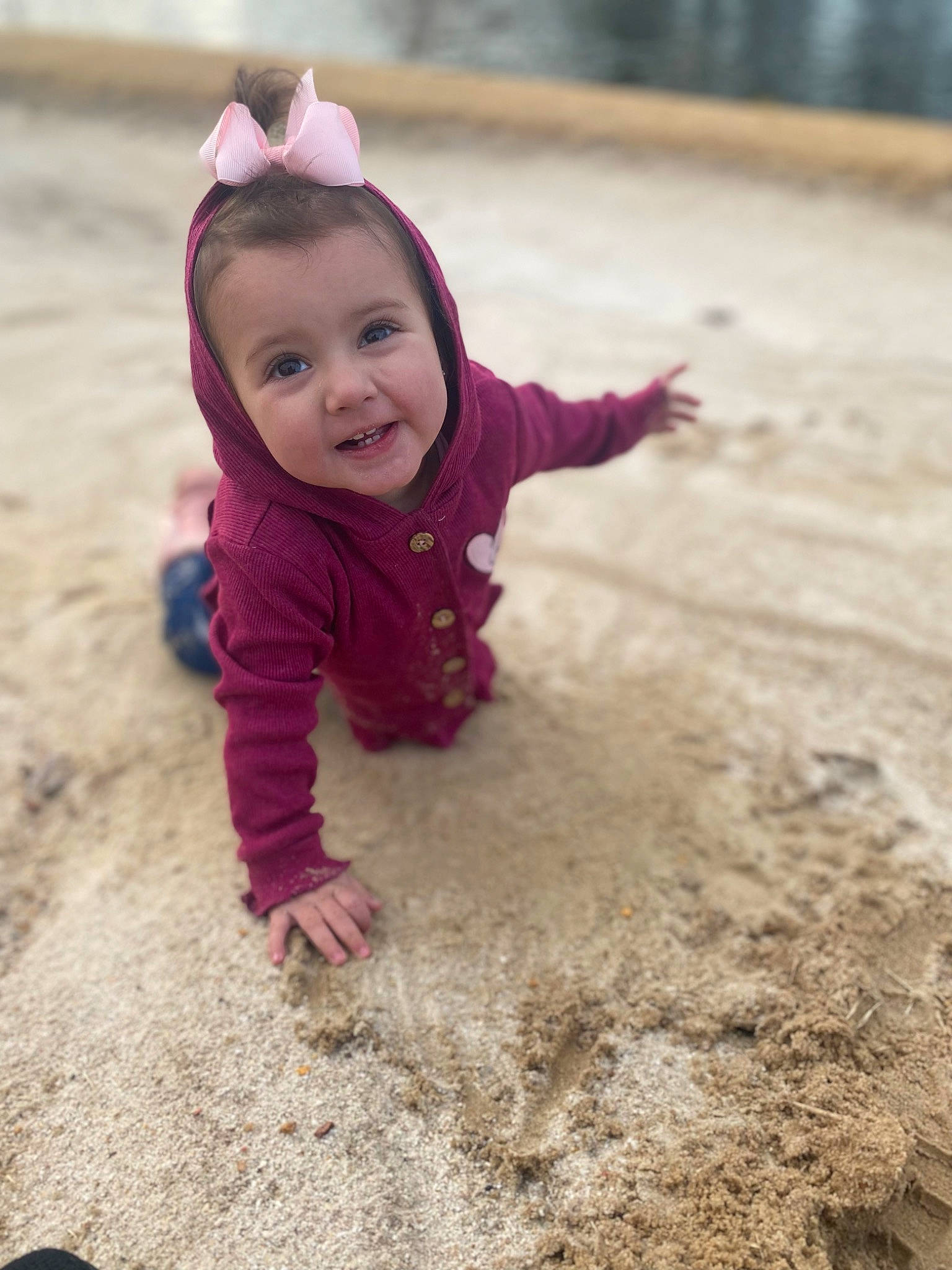 Emberlee is registered to the contest to win money with this photo: asphalt, baby, baby_toddler_clothing, child, face, flooring, fun, grass, happy, magenta, people_in_nature, person, play, recreation, road_surface, sand, sitting, smile, soil, toddler