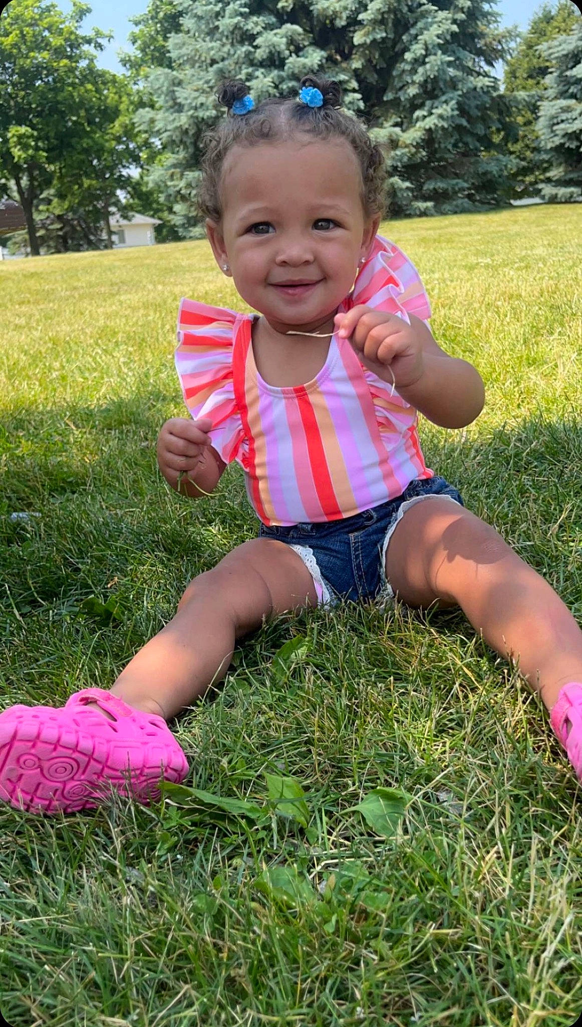 Jori joined the competition — help win amazing prizes! baby_toddler_clothing, child, clothing, eye, face, facial_expression, finger, fun, grass, grass_family, happy, joy, lawn, meadow, people_in_nature, person, pink, plant, smile, summer