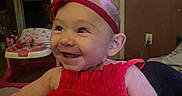 Brinlee joined the competition — help win amazing prizes! baby, baby_walker, child, clothing, cute, face, furniture, happy, headband, indoor, infant, joyful, person, playful, portrait, red_dress, room, seated, smiling, toothy_grin