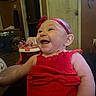 Brinlee is registered to the contest to win money with this photo: baby, child, smiling, red_dress, headband, indoor, happy, person, infant, cute, portrait, furniture, toy, room, skin, face, sitting, cheerful, young, head