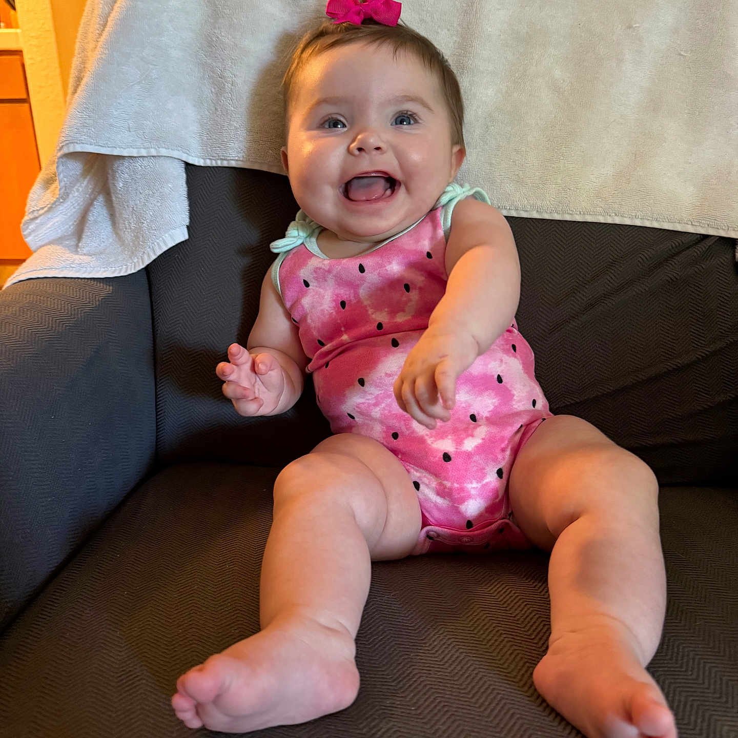 Lillian is registered to the contest to win money with this photo: accessories, baby, bodypart, chair, clothing, couch, cushion, diaper, dress, face, finger, furniture, hand, happy, head, homedecor, person, photography, portrait, sitting