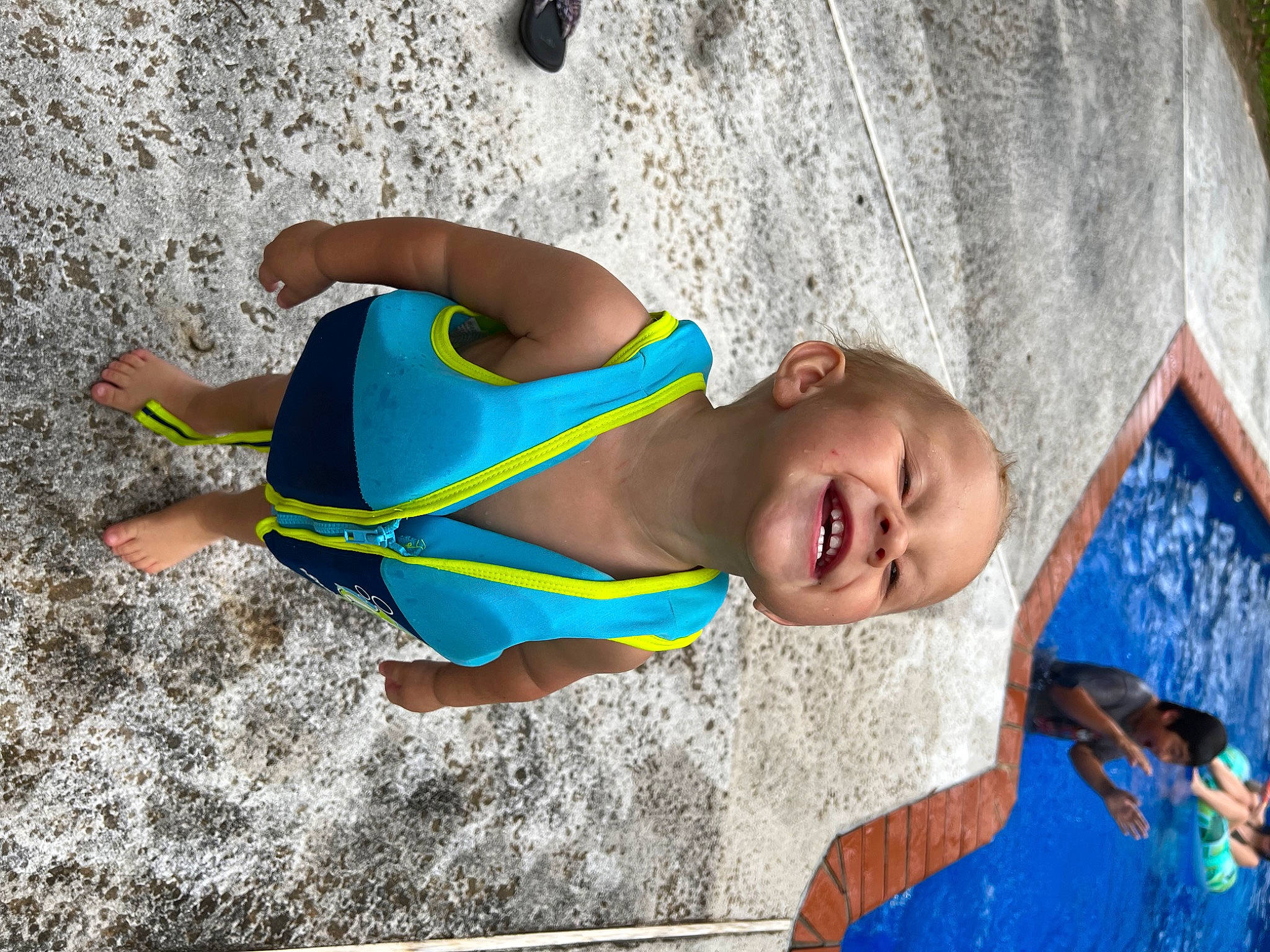 Malakai is registered to the contest to win money with this photo: abdomen, blue, chest, child, electric_blue, eyewear, fun, happy, human_leg, joy, leisure, person, personal_protective_equipment, recreation, sand, smile, sunglasses, swimwear, thigh, toddler