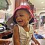 Nasir Cayden joined the competition — help win amazing prizes! appliance, baby, bottle, cabinet, cap, child, clothing, counter, face, hand, happy, home, indoor, kitchen, light, person, red_cap, sitting, smiling, table