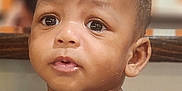 Nasir Cayden is registered to the contest to win money with this photo: toddler, child, face, portrait, curious, indoor, casual_clothing, short_hair, skin, expression, person, young_child, looking_away, baby, head_and_shoulders, seated, cute, human, closeup, innocent