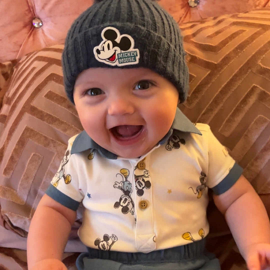 Thomas joined the competition — help win amazing prizes! architecture, baby, babylaughing, beanie, bodypart, cap, clothing, couch, face, finger, furniture, hand, happy, hat, head, pants, person, photography, portrait, shorts