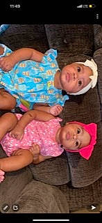 The Twins joined the competition — help win amazing prizes! baby, baby_toddler_clothing, cheek, child, comfort, facial_expression, finger, fun, happy, headwear, human_leg, lap, nose, pattern, person, pink, sitting, skin, textile, thigh