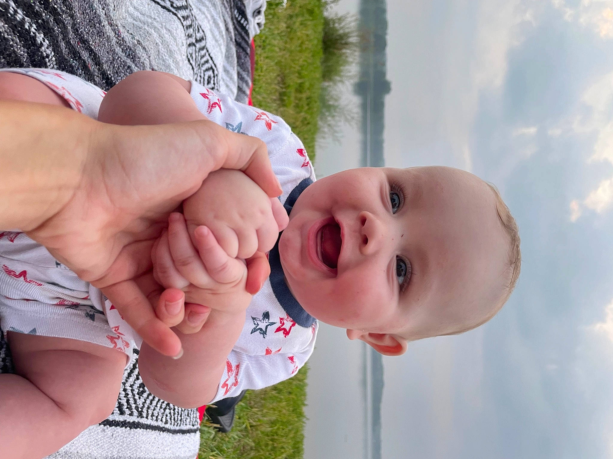 Odin is registered to the contest to win money with this photo: baby, baby_toddler_clothing, cloud, face, finger, gesture, grass, happy, joy, leisure, lip, mouth, nose, people_in_nature, person, skin, sky, smile, thumb, toddler