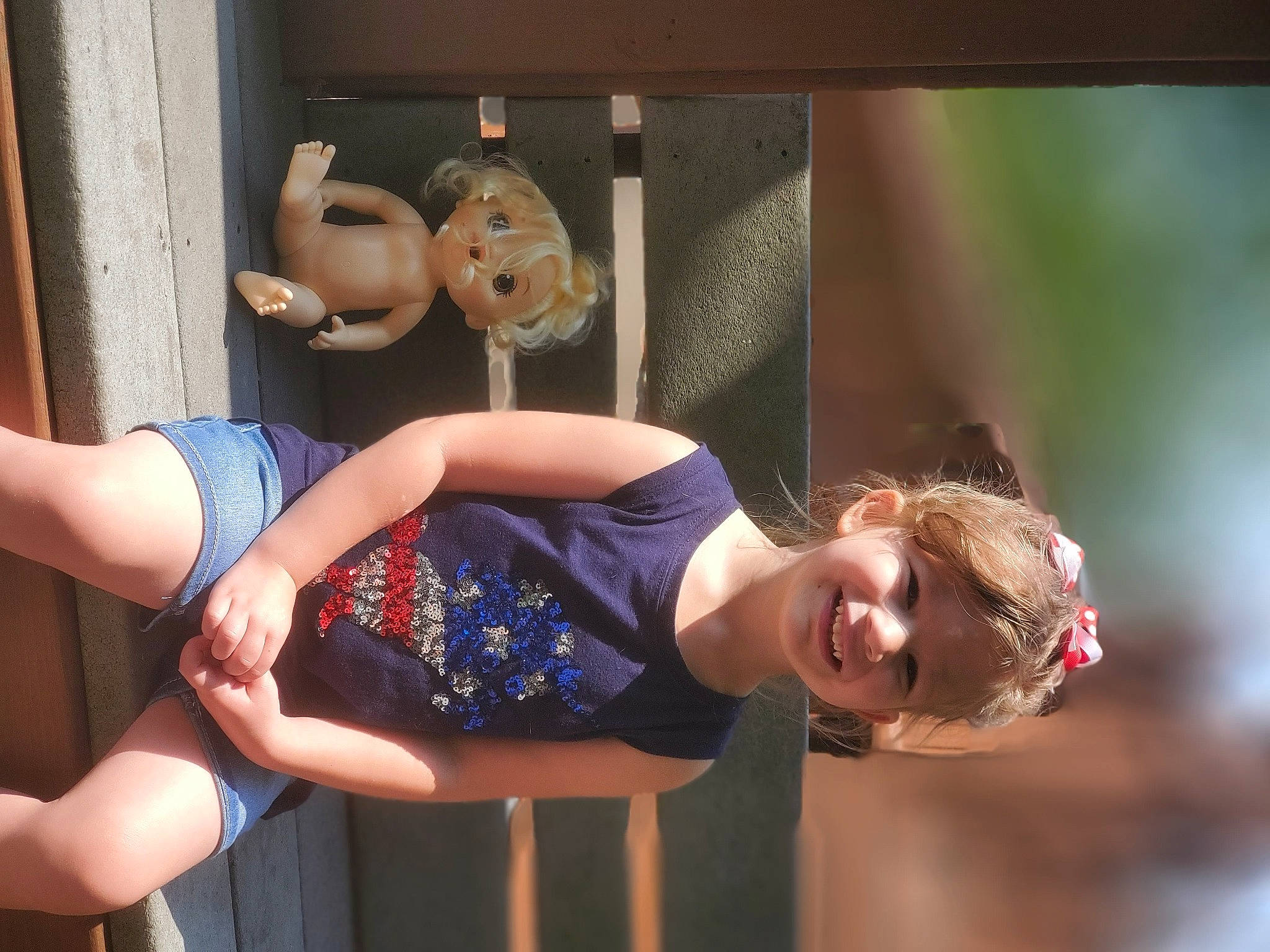 Dixie is registered to the contest to win money with this photo: abdomen, barefoot, child, elbow, flash_photography, foot, fun, happy, human_leg, joy, knee, leisure, person, sandal, sitting, smile, sportswear, thigh, toy, trunk