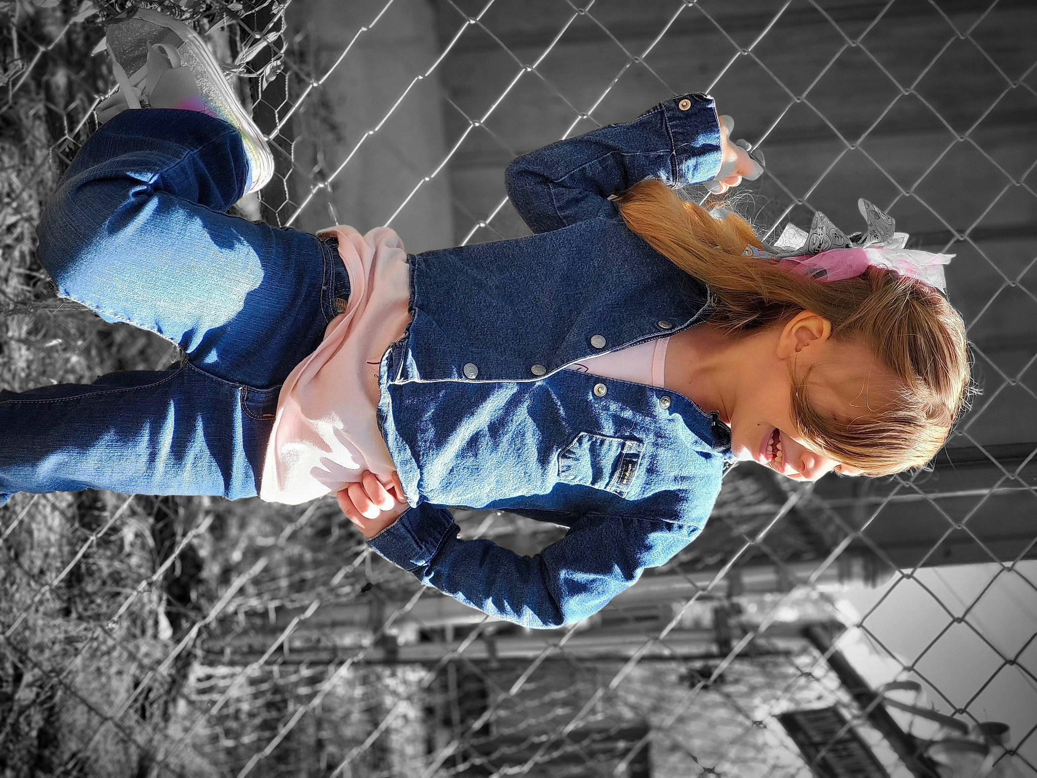 Dixie is registered to the contest to win money with this photo: child, denim, electric_blue, eyewear, fence, flash_photography, fun, grass, happy, leisure, mesh, net, pattern, people_in_nature, person, player, sitting, street_fashion, tree, winter