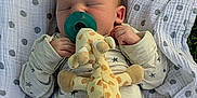 Knoxtin is registered to the contest to win money with this photo: baby, blanket, child, clothing, cozy, cute, giraffe, grass, infant, newborn, outdoor, pacifier, peaceful, plush_toy, polka_dot, portrait, resting, sleeping, soft, toddler