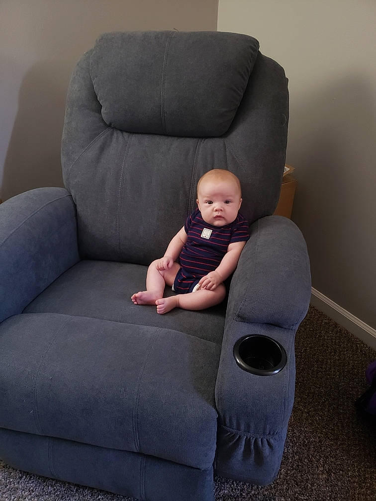 Theo joined the competition — help win amazing prizes! baby, baby_products, baby_toddler_clothing, chair, child, club_chair, comfort, couch, flooring, fun, furniture, head, knee, lap, living_room, person, room, sitting, studio_couch, toddler