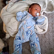 Kaleb joined the competition — help win amazing prizes! baby, infant, pacifier, blue_onesie, blanket, soft_texture, lying_down, cute, cozy, sleepwear, bedroom, comfort, child, sleep, portrait, newborn, indoors, warm_clothing, face, resting