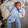 baby, infant, pacifier, blue_onesie, blanket, soft_texture, lying_down, cute, cozy, sleepwear, bedroom, comfort, child, sleep, portrait, newborn, indoors, warm_clothing, face, resting
