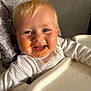 Lillian is registered to the contest to win money with this photo: baby, baby_food, blond_hair, cheeks, child, close_up, cute, feeding_time, food, happy, high_chair, indoor, infant, messy_face, playful, portrait, seat, smile, teeth, white_clothing