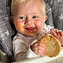Lillian joined the competition — help win amazing prizes! baby, blond_hair, blue_eyes, child, clothing, cookie, crumbs, face, food, hand, happy, high_chair, indoor, messy_face, mouth, person, portrait, seat_cushion, smiling, stars_pattern