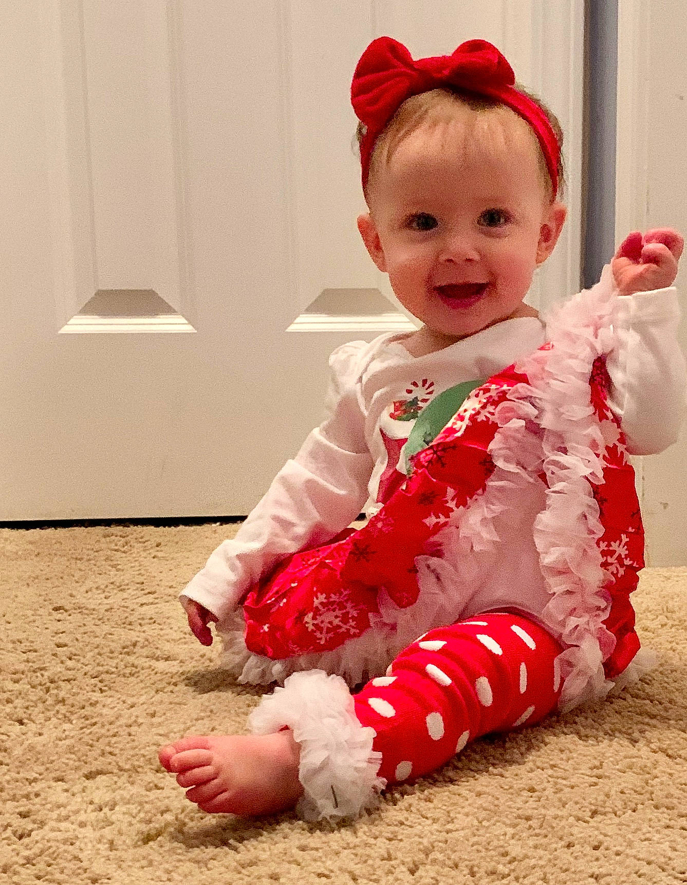 Kailee joined the competition — help win amazing prizes! baby, baby_toddler_clothing, cheek, child, christmas_eve, dress, ear, footwear, head, leg, outerwear, pajamas, person, pink, red, sitting, skin, sleeve, smile, textile
