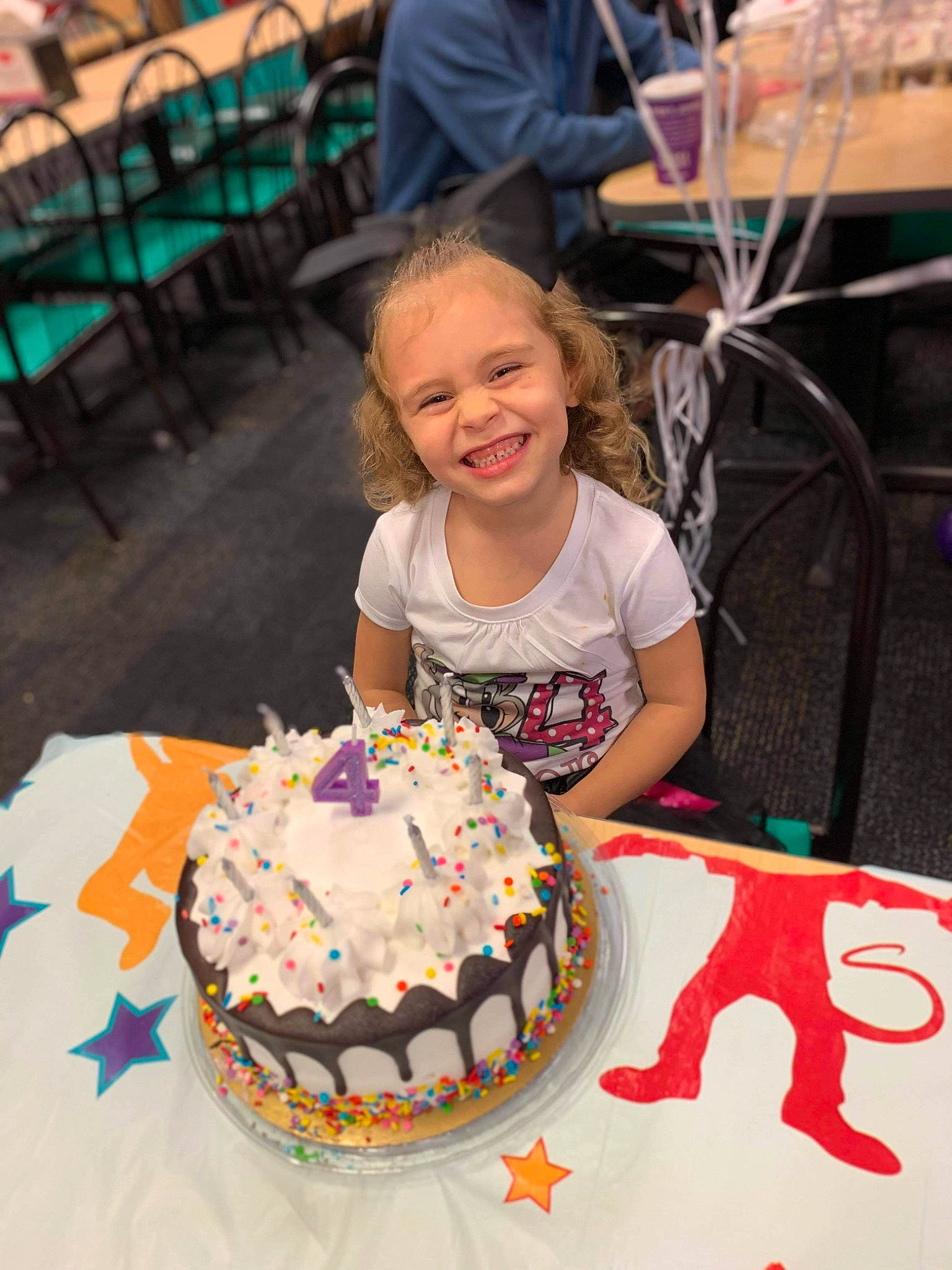 Kyler is registered to the contest to win money with this photo: baked_goods, birthday_cake, buttercream, cake, cake_decorating, cake_decorating_supply, chair, event, food, fun, green, joy, leisure, person, pink, smile, sugar_cake, sugar_paste, sweetness, t_shirt
