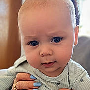 Ozzy joined the competition — help win amazing prizes! baby, child, blue_eyes, close_up, expression, face, hands, nail_polish, rings, clothing, indoor, person, skin, portrait, cute, infant, holding, focus, soft_light, background_blur