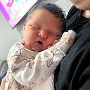 Aurora-Mae is registered to the contest to win money with this photo: baby, sleeping, infant, face, person, adult, black_shirt, clothing, portrait, closeup, newborn, resting, cozy, indoor, soft_light, hand, blanket, cuddle, parent, family