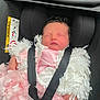 Aurora-Mae is registered to the contest to win money with this photo: baby, newborn, car_seat, sleeping, pink_dress, white_sweater, straps, child, infant, cute, face, hands, fabric, seatbelt, transportation, safety, indoor, portrait, peaceful, rest
