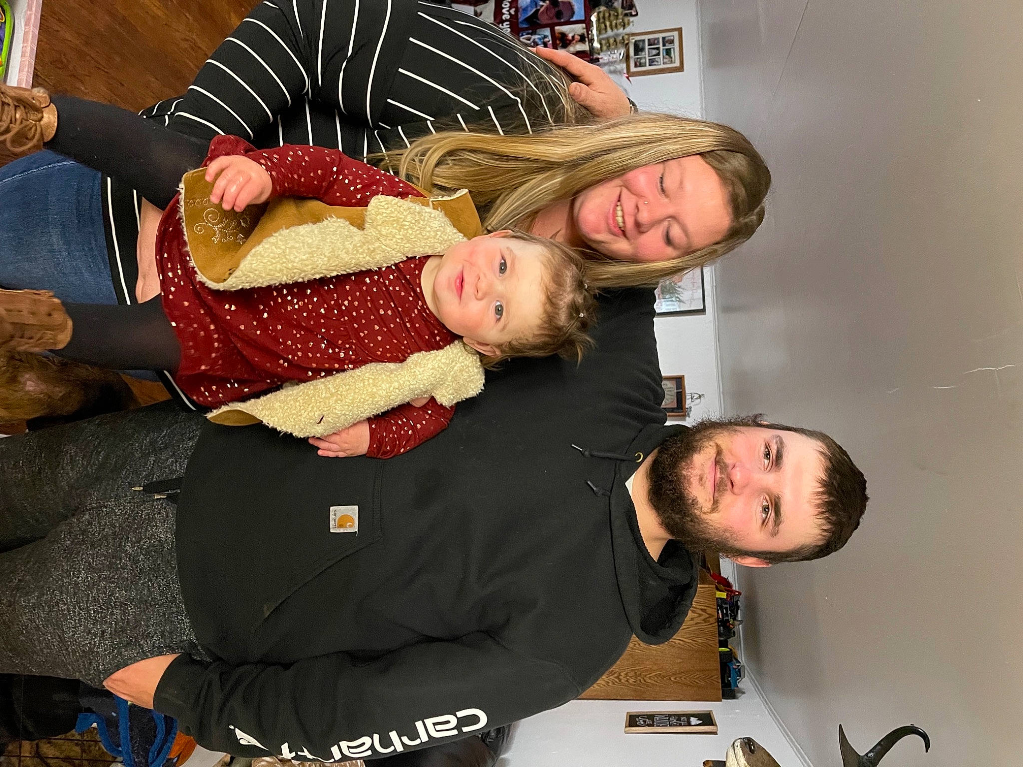 Opal is registered to the contest to win money with this photo: arm, baby, child, comfort, event, facial_expression, fun, gesture, happy, interaction, joy, lap, organ, person, room, sitting, smile, t_shirt, table, thigh