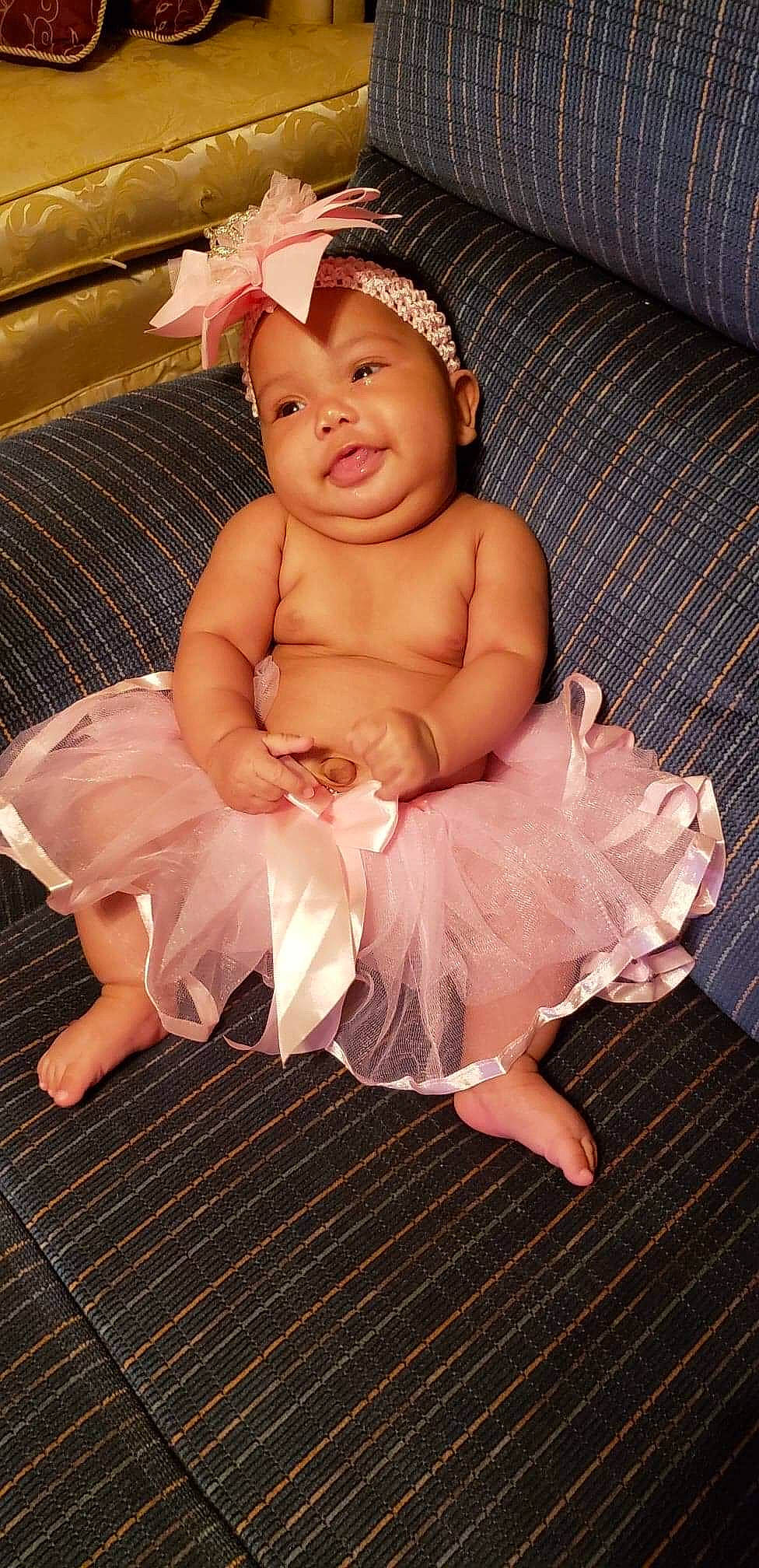 Nayely joined the competition — help win amazing prizes! abdomen, child, finger, flooring, fun, girl, hair_accessory, hand, human_hair_color, infant, leg, muscle, person, pink, product, sitting, skin, smile, thigh, toddler