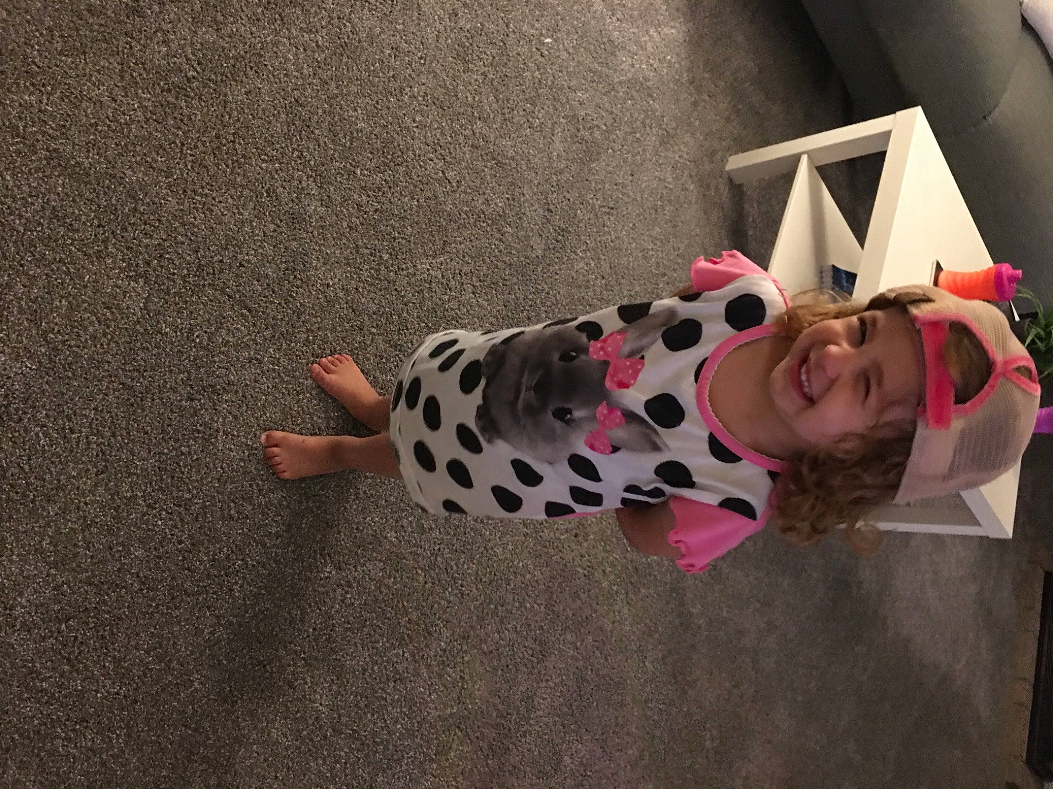 Kinzley joined the competition — help win amazing prizes! carmine, child, eyewear, flooring, foot, fun, headwear, joy, non_sporting_group, pattern, person, room, smile, toddler, toy, visual_arts