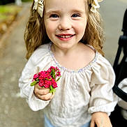 Ivanka joined the competition — help win amazing prizes! child, girl, smile, flowers, holding, blonde_hair, bows, outdoor, portrait, happy, cute, casual_clothing, nature, daylight, person, young_child, closeup, face, flower_bouquet, background_blur