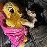 puppy, stuffed_animal, blanket, pink, yellow, paw_prints, cozy, soft, toy, sleeping, cute, pet, animal, fur, resting, bed, comfort, friendship, indoor, snuggle