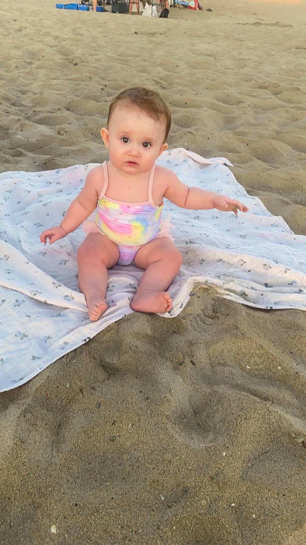 Khaleesi joined the competition — help win amazing prizes! baby, barefoot, beach, child, foot, fun, happy, head, human_leg, leg, leisure, ocean, people_in_nature, people_on_beach, person, sand, shorts, sitting, surprise, thigh