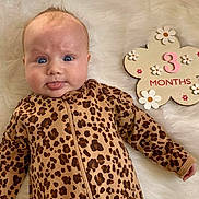 Harper joined the competition — help win amazing prizes! baby, infant, leopard_print, onesie, tongue_out, blue_eyes, fluffy_blanket, flower_sign, 3_months, cute, milestone, lying_down, child, smiling, soft_texture, playful, closeup, person, portrait, young