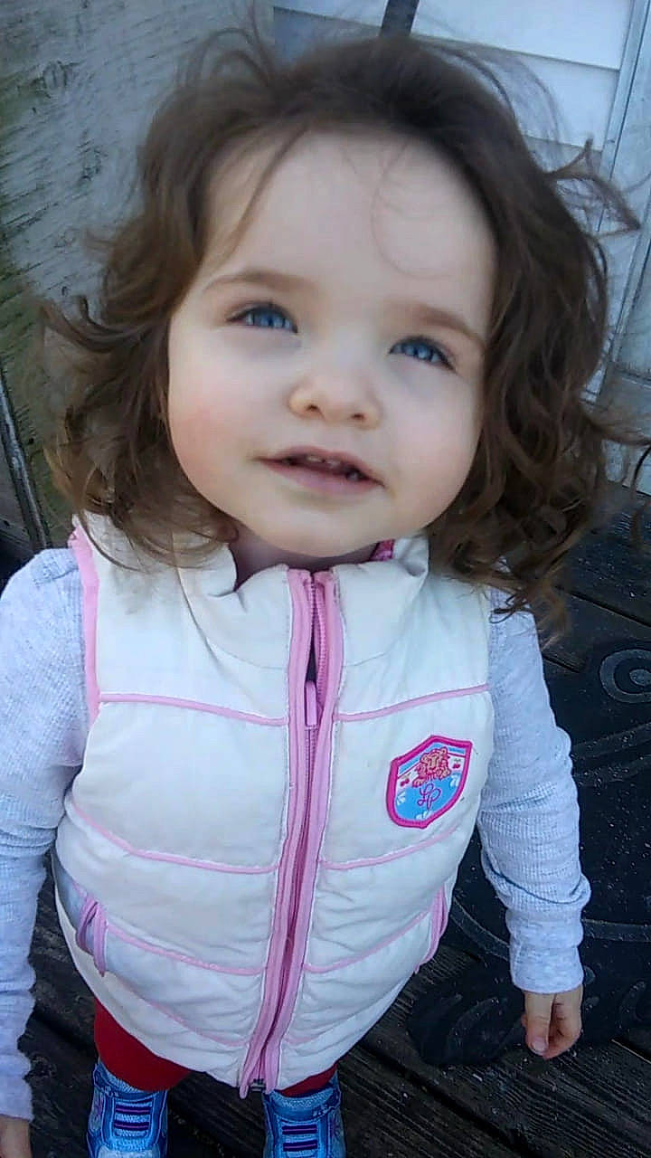 Justice is registered to the contest to win money with this photo: baby, beauty, brown_hair, cheek, child, child_model, eye, face, head, iris, lip, nose, outerwear, person, pink, skin, smile, toddler