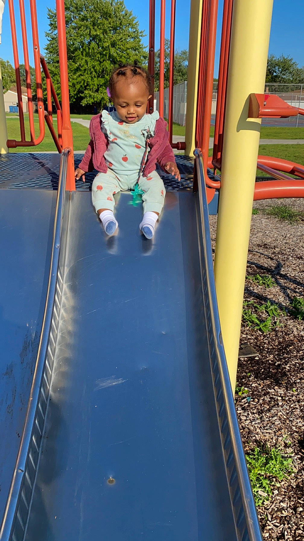 Zuri is registered to the contest to win money with this photo: baby, baby_toddler_clothing, child, chute, city, electric_blue, fun, grass, leisure, nonbuilding_structure, outdoor_play_equipment, person, plant, play, playground, playground_slide, recreation, shade, sky, toddler