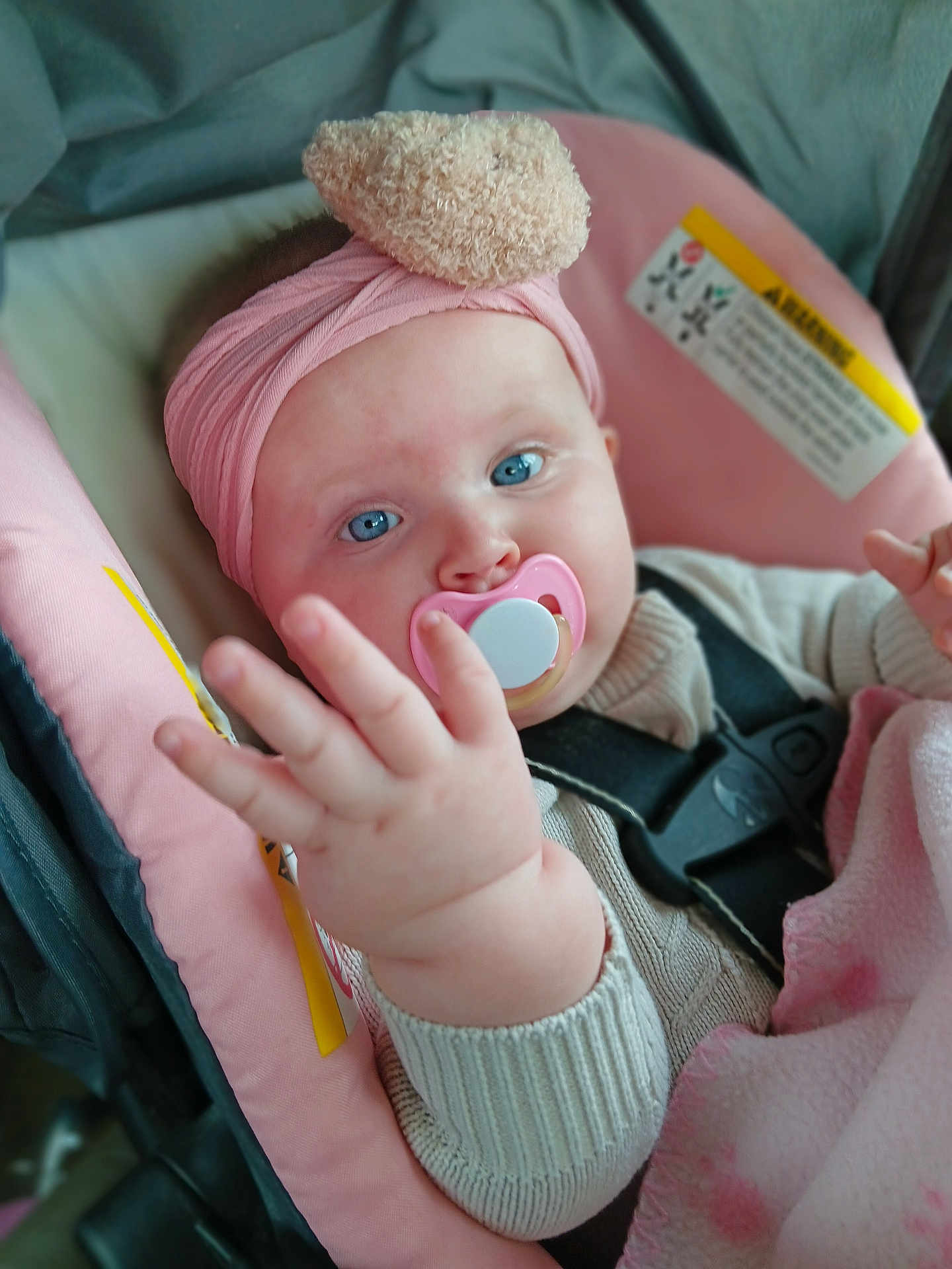 Renezmay joined the competition — help win amazing prizes! baby, infant, pacifier, headband, blue_eyes, car_seat, pink, blanket, clothing, hand, face, child, cute, straps, sweater, indoor, portrait, young, soft, cozy