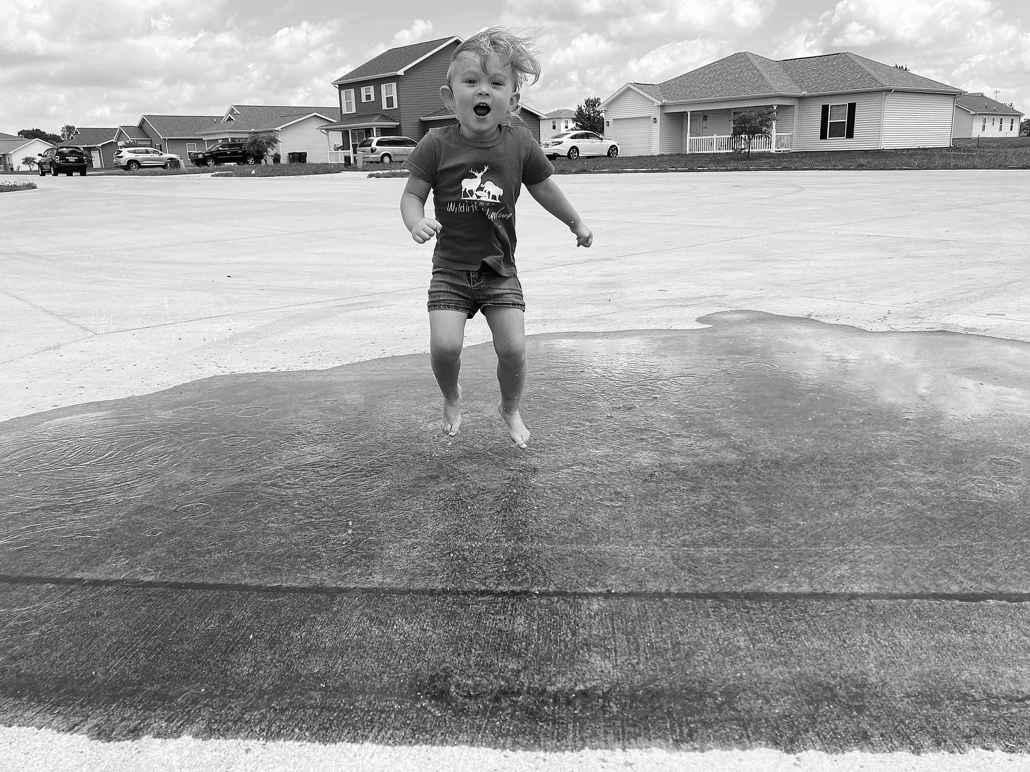 Taylor joined the competition — help win amazing prizes! asphalt, black, black_and_white, building, cloud, gesture, landscape, monochrome, monochrome_photography, person, road, road_surface, shorts, sky, standing, style, t_shirt, tar, toddler, white