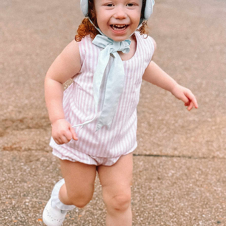 Avanna is registered to the contest to win money with this photo: bonnet, cap, child, clothing, dress, face, female, footwear, girl, grass, hat, head, person, photography, plant, portrait, scarf, shoe, shorts, sunhat