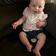 Lily joined the competition — help win amazing prizes! baby, child, smiling, couch, indoor, clothing, pacifier, denim, pink, shorts, happy, face, person, infant, sitting, cute, furniture, skin, hand, foot