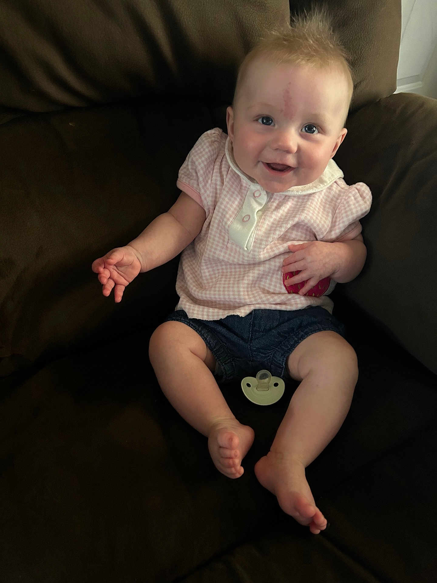Lily joined the competition — help win amazing prizes! baby, child, smiling, couch, indoor, clothing, pacifier, denim, pink, shorts, happy, face, person, infant, sitting, cute, furniture, skin, hand, foot