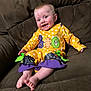 baby, child, smile, happy, polka_dot, yellow_clothing, purple_clothing, sitting, couch, furniture, indoor, face, feet, barefoot, person, infant, cute, holiday, halloween, decorative