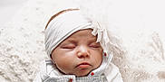 Alayah-Ray is registered to the contest to win money with this photo: baby, sleeping, headband, flower, infant, clothing, buttons, blanket, soft, cozy, cute, portrait, peaceful, newborn, closeup, face, child, resting, white, texture