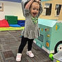 toddler, child, playroom, toy, food_truck, basket, carpet, cushions, play, happy, smiling, clothing, shoes, indoor, fun, young_child, pretend_play, furniture, colorful, expression