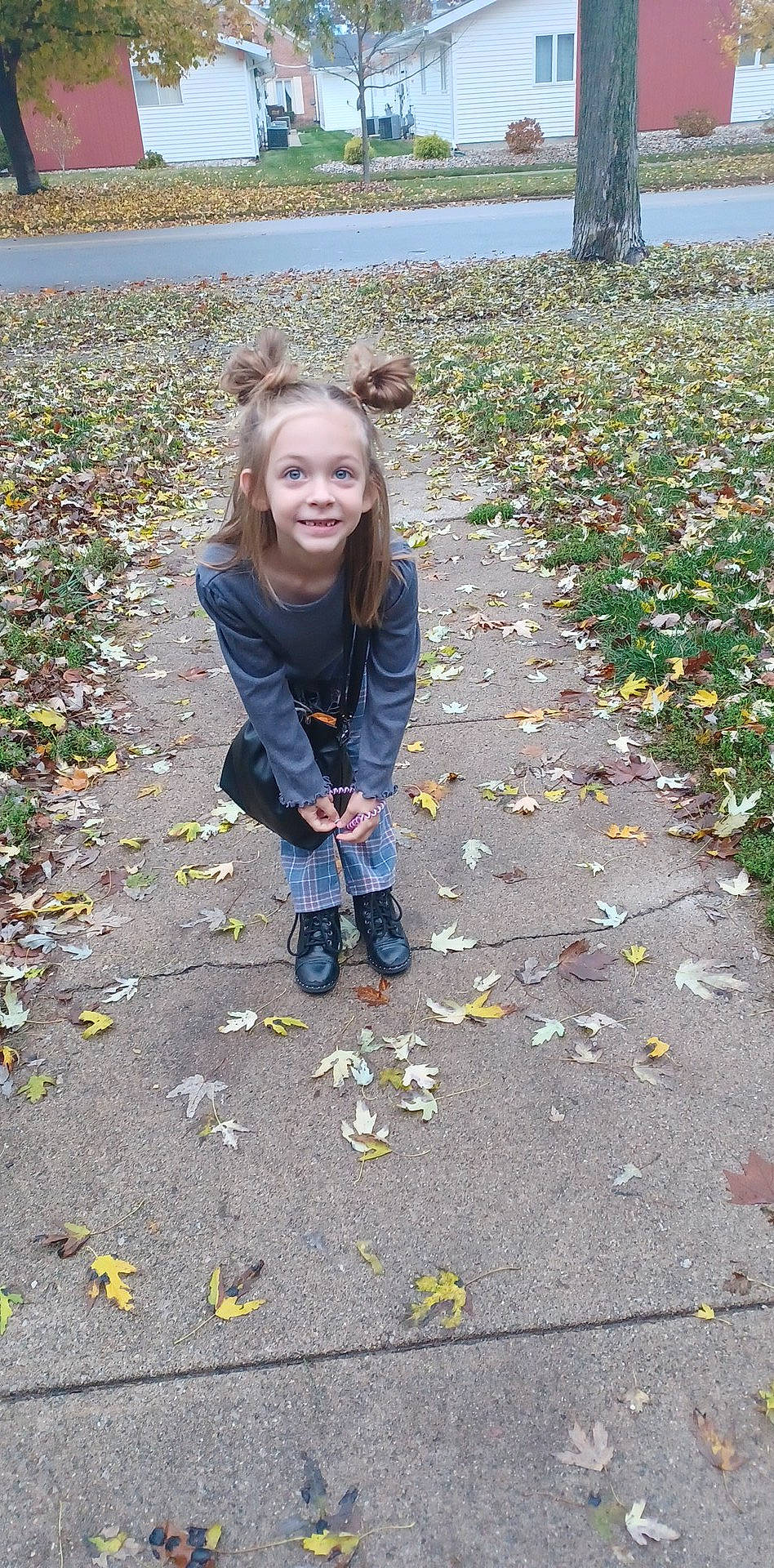 Everleigh is registered to the contest to win money with this photo: adaptation, asphalt, child, deciduous, flooring, grass, happy, human_leg, joy, pattern, people_in_nature, person, plant, road_surface, shadow, sidewalk, sitting, smile, soil, toddler