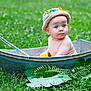 baby, child, blue_eyes, hat, knitted_hat, metal_tub, grass, greenery, rubber_duck, toy_fishing_rod, outdoor, nature, leaves, infant, cute, portrait, sitting, curious, summer, playtime