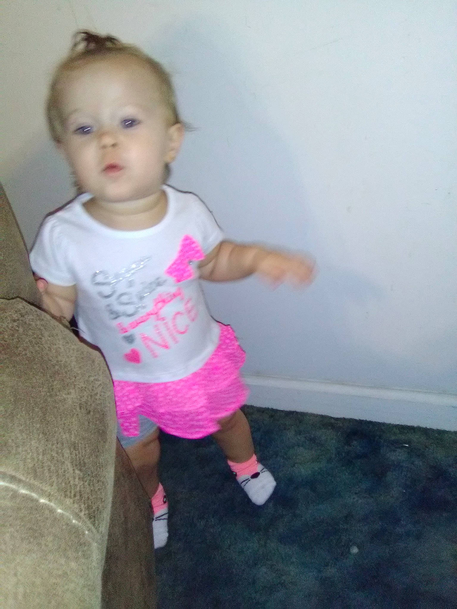 Briley is registered to the contest to win money with this photo: baby, cheek, child, fun, joint, leg, person, pink, play, shoe, shoulder, skin, standing, t_shirt, toddler