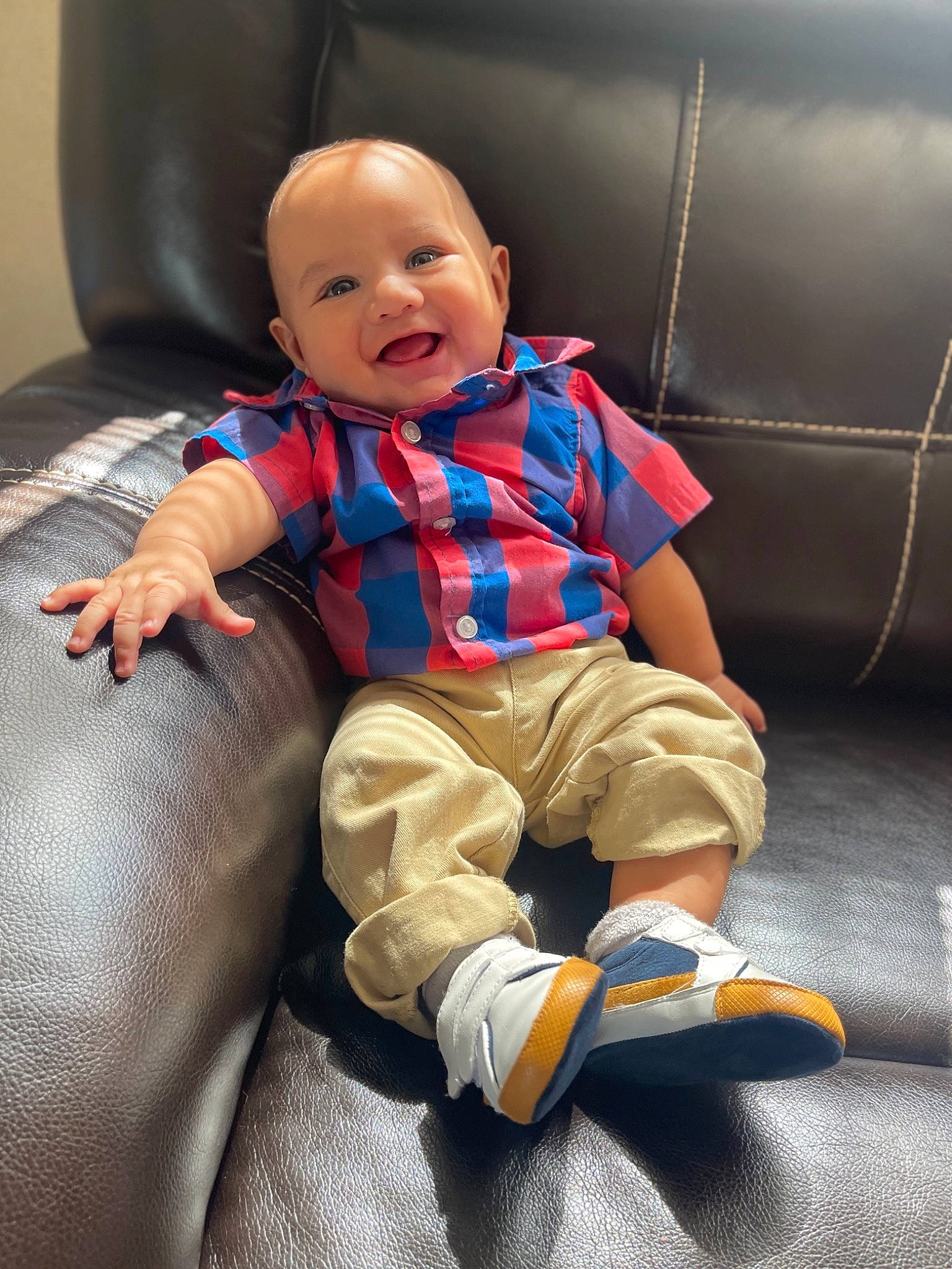 Adriel is registered to the contest to win money with this photo: baby, baby_toddler_clothing, child, comfort, electric_blue, face, flooring, fun, happy, human_leg, joy, lap, mammal, person, sitting, sleeve, smile, sneakers, sock, t_shirt