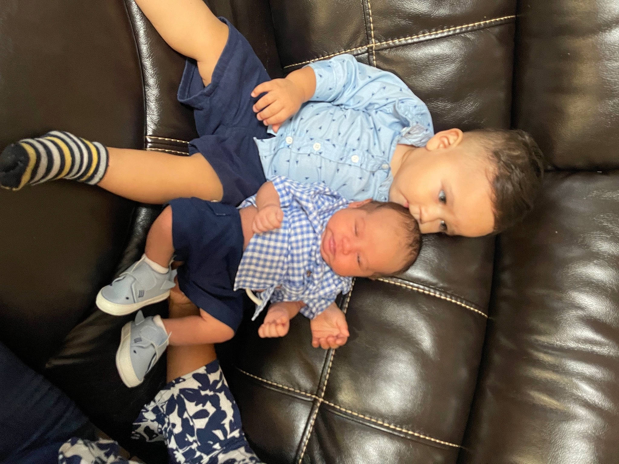Antonio is registered to the contest to win money with this photo: baby, baby_products, baby_toddler_clothing, black, comfort, couch, elbow, finger, fun, gesture, human_body, human_leg, joint, knee, lap, leg, person, sock, thigh, thumb