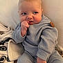 Rowin is registered to the contest to win money with this photo: baby, infant, child, sitting, blanket, pajamas, waffle_knit, hand, fingers, chubby_cheeks, eyes, side_eye, portrait, indoor, soft_light, curious_expression, button, bedding, cozy, blanket_pattern
