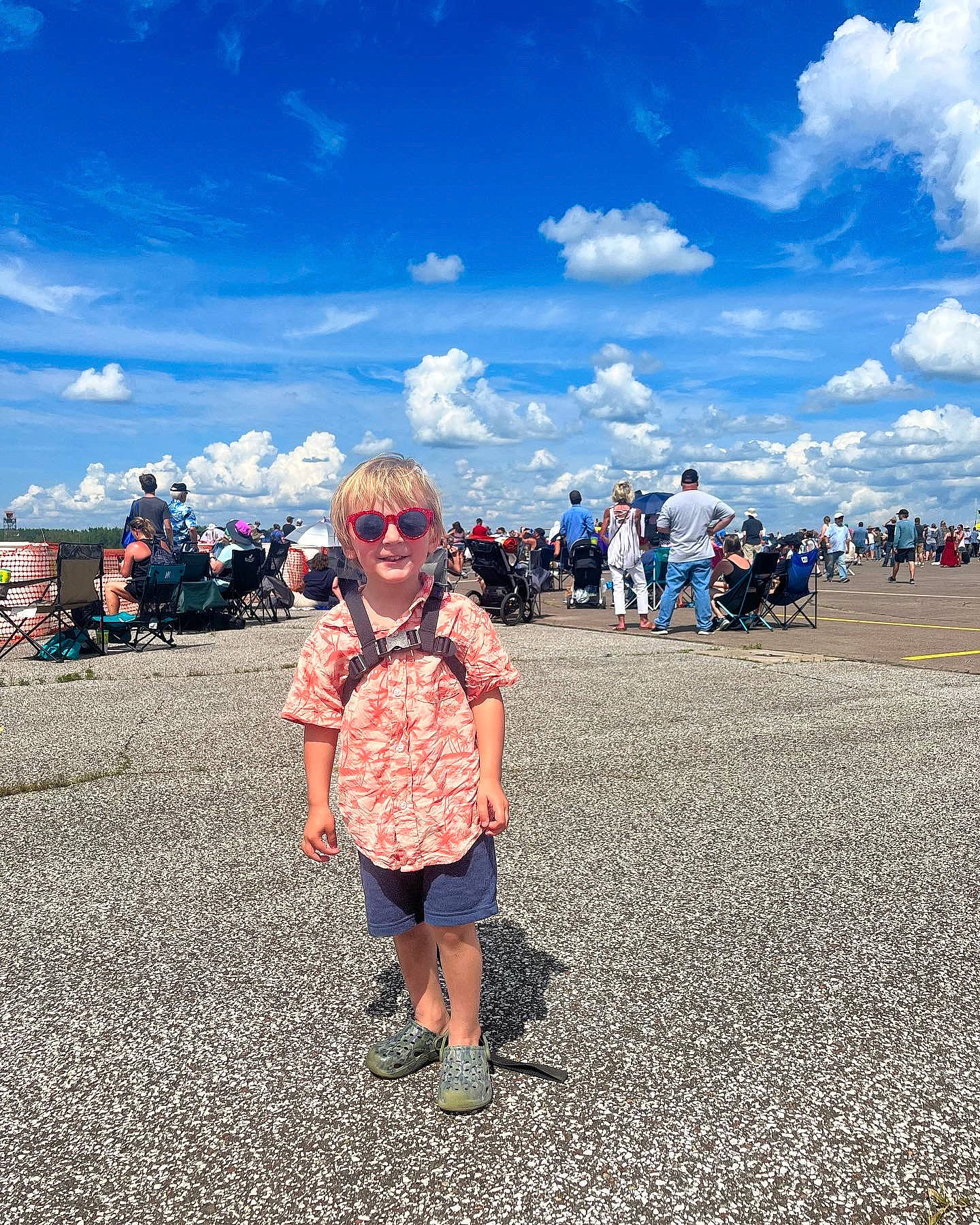 Steven is registered to the contest to win money with this photo: asphalt, blue, body_of_water, cloud, cumulus, fun, goggles, happy, horizon, human, joy, landscape, leisure, people_in_nature, person, sky, smile, summer, sunglasses, toddler