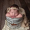 Ashlyn joined the competition — help win amazing prizes! newborn, baby, sleeping, infant, portrait, headband, floral, bucket, vintage, metal, blanket, crochet, wooden_floor, studio, cozy, peaceful, hands, face, closed_eyes, photography